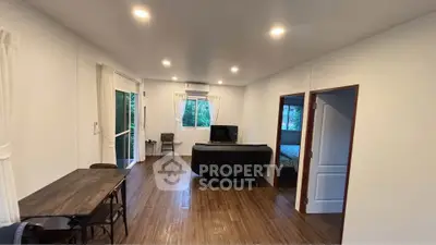 Spacious living room with modern decor and large windows for natural light.