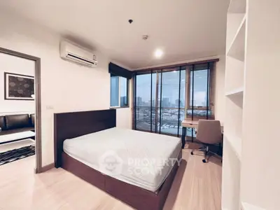 Modern bedroom with city view, featuring a cozy bed and study area.