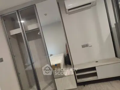 Modern bedroom with sleek wardrobe and air conditioning unit