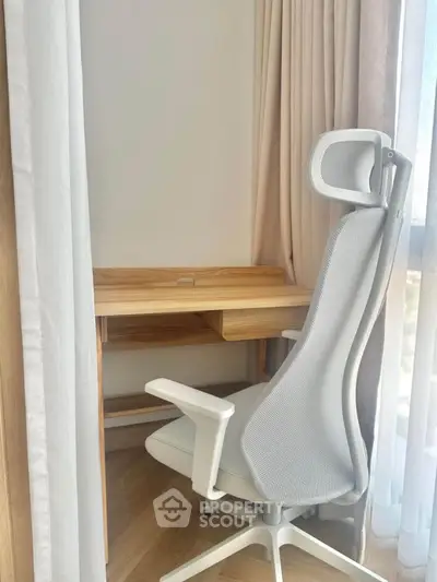 Cozy study nook with ergonomic chair and wooden desk by a sunlit window, perfect for productivity.