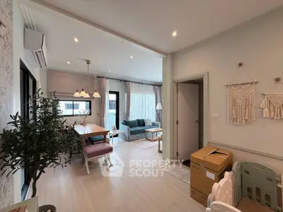 Stylish open-plan living and dining area with modern decor and natural light.