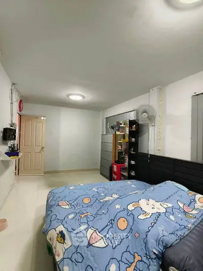 Cozy bedroom with modern decor and ample storage space, perfect for relaxation and comfort.