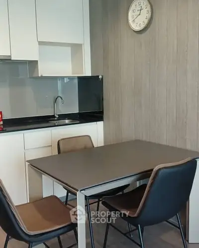Modern kitchen with sleek dining area and stylish chairs