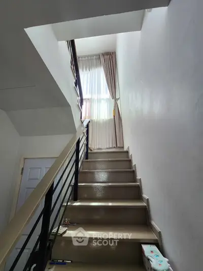 Bright stairway with natural light and elegant curtains