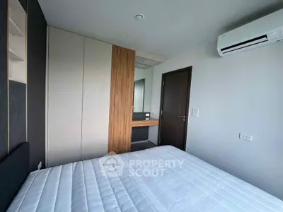 Modern bedroom with built-in wardrobe and air conditioning unit