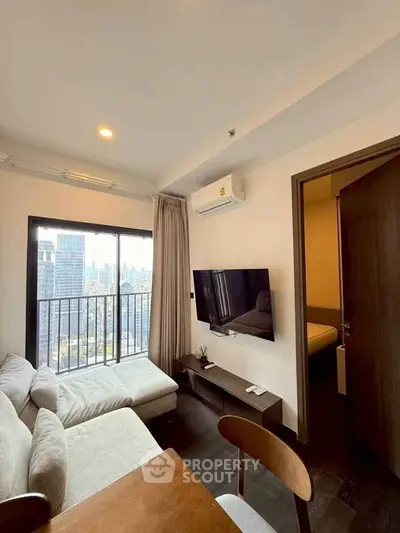 Modern living room with city view, cozy sofa, and wall-mounted TV in a high-rise apartment.