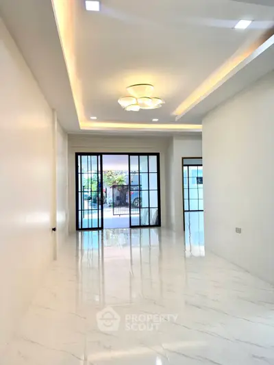 Spacious modern living room with elegant lighting and large windows