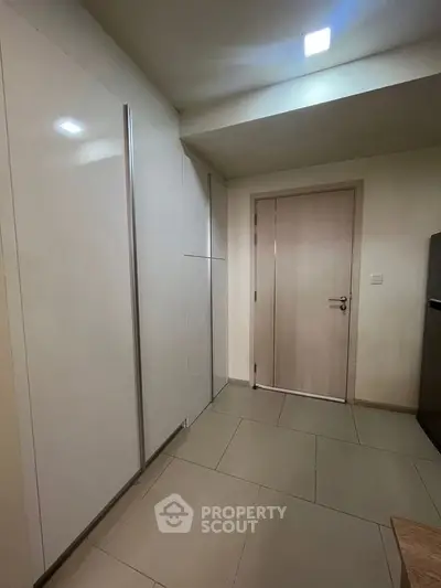 Modern kitchen with sleek cabinetry and tiled flooring