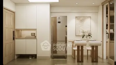 Modern kitchen with sleek design, featuring a stainless steel fridge and elegant dining area.
