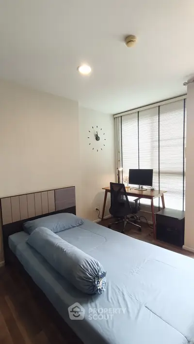 Modern bedroom with study area featuring a sleek desk and comfortable bed, perfect for productivity and relaxation.