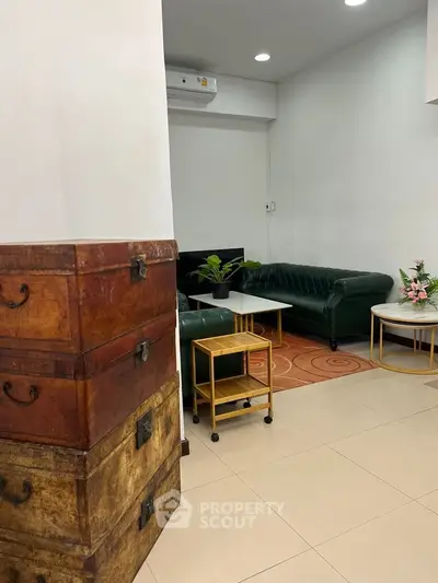 Charming living room with vintage decor and elegant green sofas, perfect for cozy gatherings.