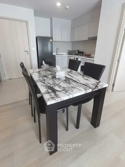 Modern kitchen with marble dining table and sleek black chairs