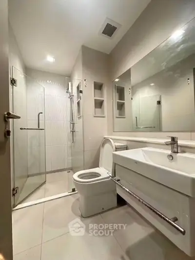 Modern bathroom with sleek fixtures and glass shower enclosure