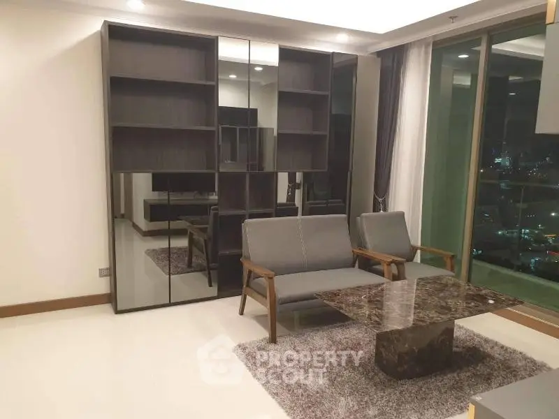 Modern living room with stylish furniture and city view, featuring a sleek marble coffee table and large windows.
