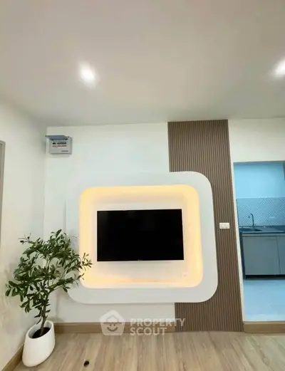 Modern living room with stylish TV wall and plant decor