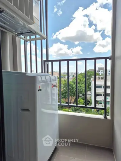 Charming balcony with washing machine and scenic city view, perfect for urban living convenience.