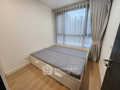 Modern minimalist bedroom with large window and stylish curtains