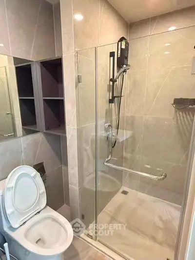 Modern bathroom with glass shower enclosure and sleek tile design