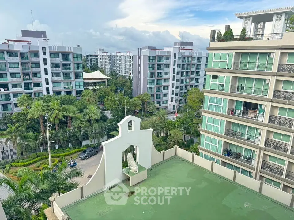 Stunning view of modern apartment complex with lush greenery and clear skies.