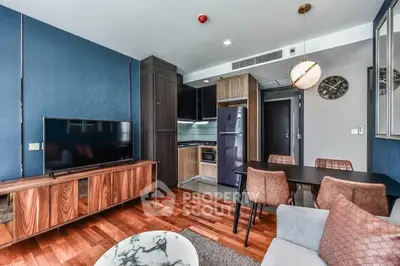 Modern living room with stylish furniture and open kitchen layout in a contemporary apartment.