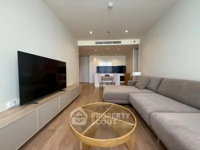 Spacious modern living room with sleek furniture and open layout, perfect for relaxation and entertainment.