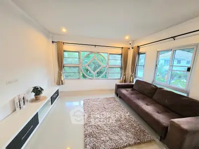 Spacious living room with large windows and modern decor