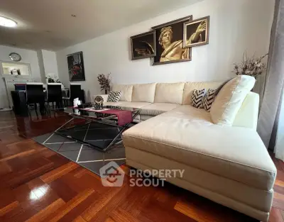 Spacious living room with elegant decor and large sectional sofa, perfect for entertaining.