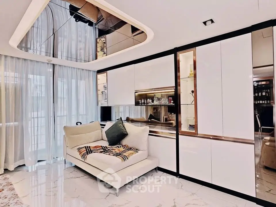 Luxurious modern living room with elegant white cabinetry and plush seating