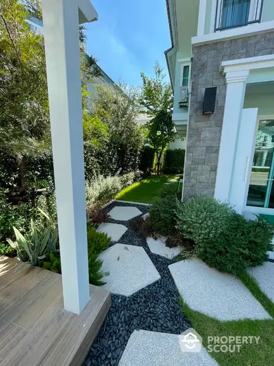 Charming garden pathway with modern landscaping and lush greenery