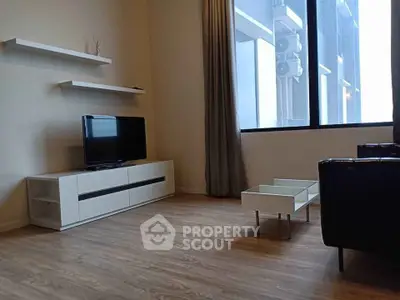 Modern living room with sleek furniture and large window view