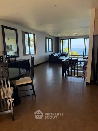 Spacious living room with ocean view and elegant dining area