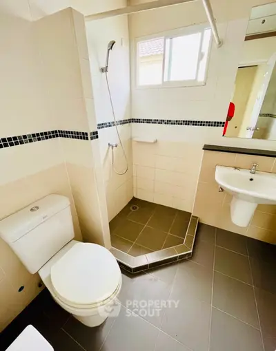 Modern bathroom with shower and sleek fixtures in a contemporary home.