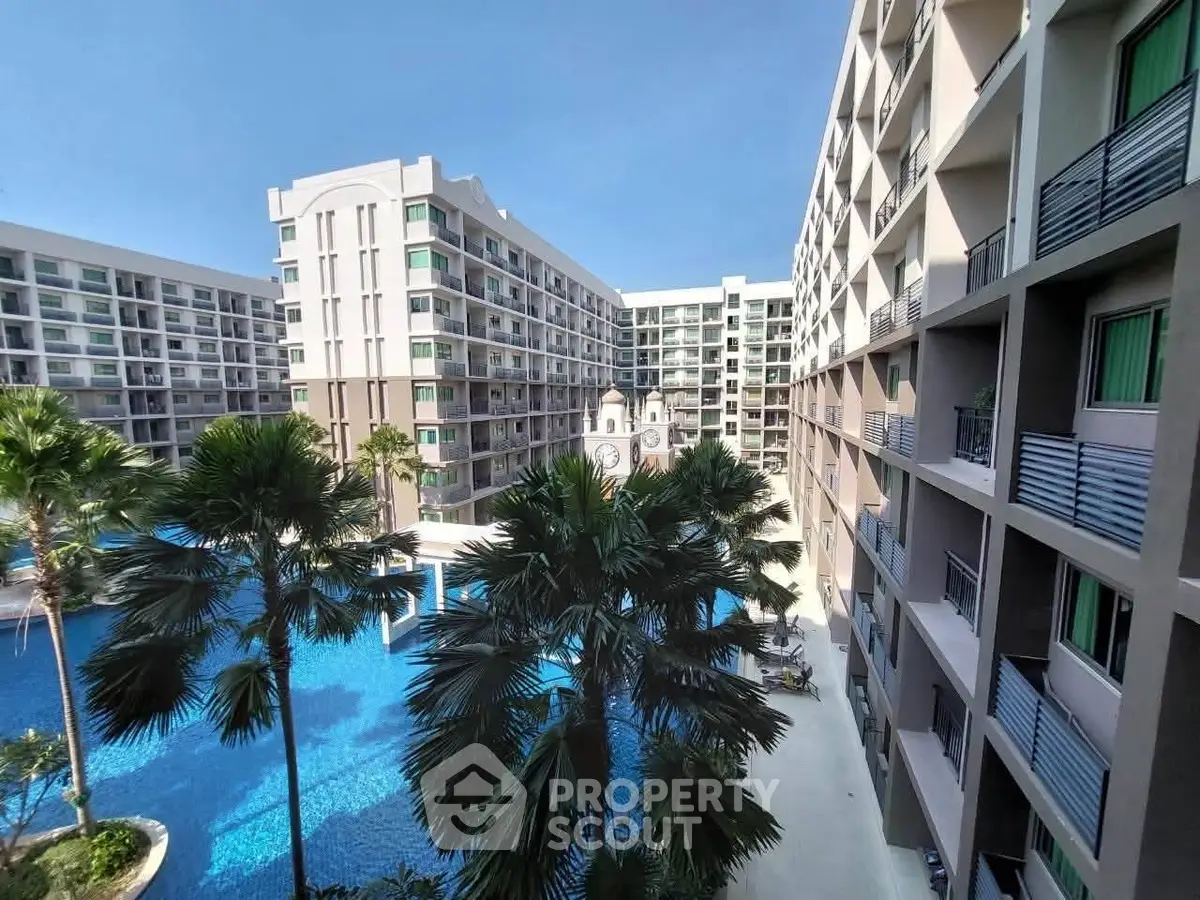 Luxurious apartment complex with stunning pool view and modern architecture.
