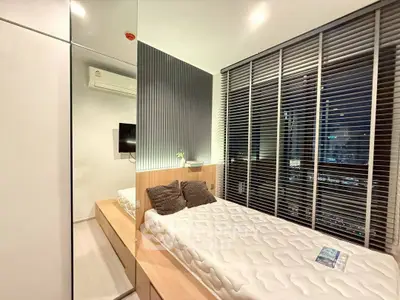 Modern bedroom with city view, sleek design, and cozy ambiance.