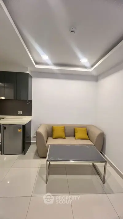 Modern living room with cozy sofa and sleek coffee table in minimalist design.