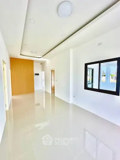 Spacious modern living room with sleek tile flooring and elegant ceiling design