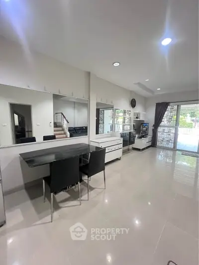 Spacious modern living room with sleek furniture and large windows for natural light.