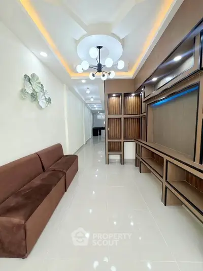 Modern living room with elegant ceiling design and stylish built-in shelving.