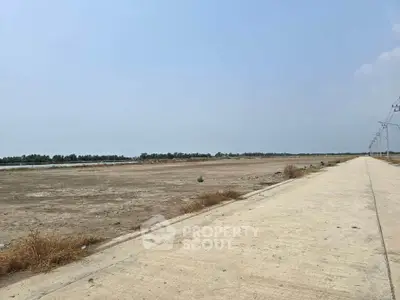 Expansive vacant land with clear skies, ideal for development opportunities.