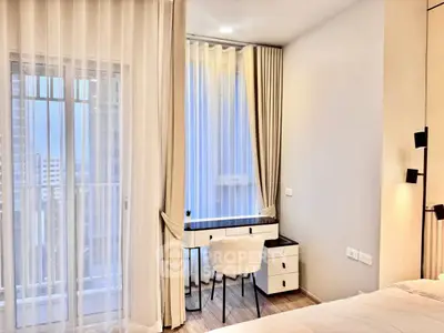 Elegant bedroom with modern desk and city view, perfect for urban living.
