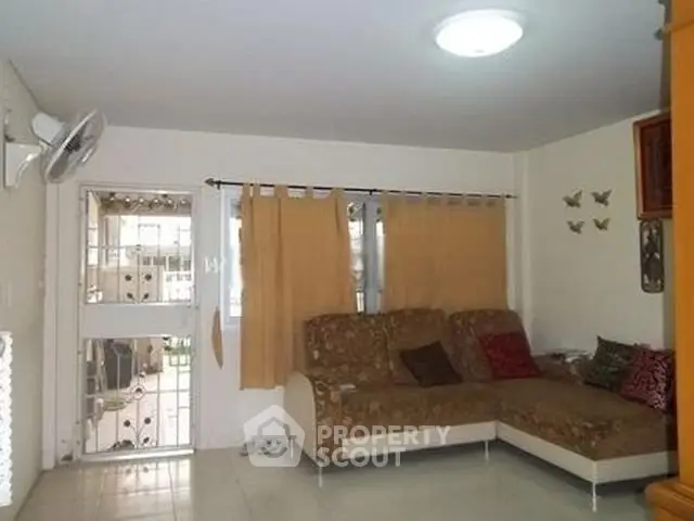 Cozy living room with sectional sofa and natural light, perfect for relaxation.