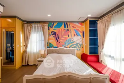 Vibrant bedroom with colorful mural and elegant furnishings, perfect for modern living.
