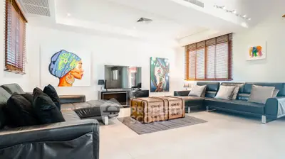 Spacious modern living room with stylish decor and leather sofas