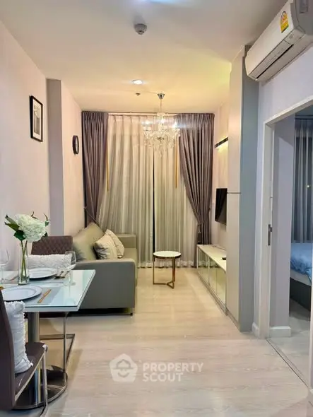 Modern living room with elegant decor and cozy ambiance in a stylish apartment.