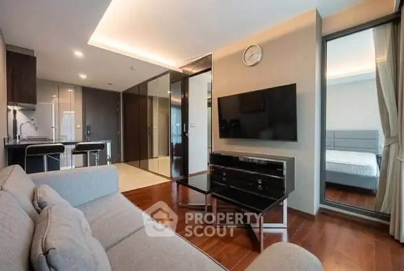 Modern living room with sleek design and open kitchen layout in a stylish apartment.