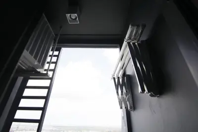 Modern balcony with sleek metal railings and expansive city view.