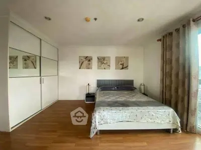 Spacious bedroom with modern decor and large wardrobe in a stylish apartment.