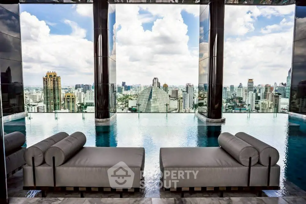 Luxurious rooftop infinity pool with stunning city skyline views and elegant lounge chairs.