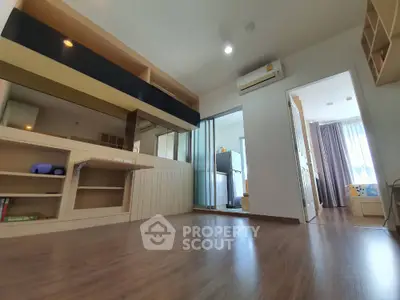 Spacious modern living area with wooden flooring and natural light