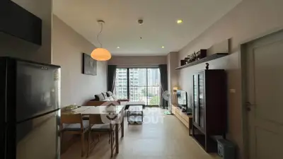 Modern living room with city view, stylish furniture, and natural light.